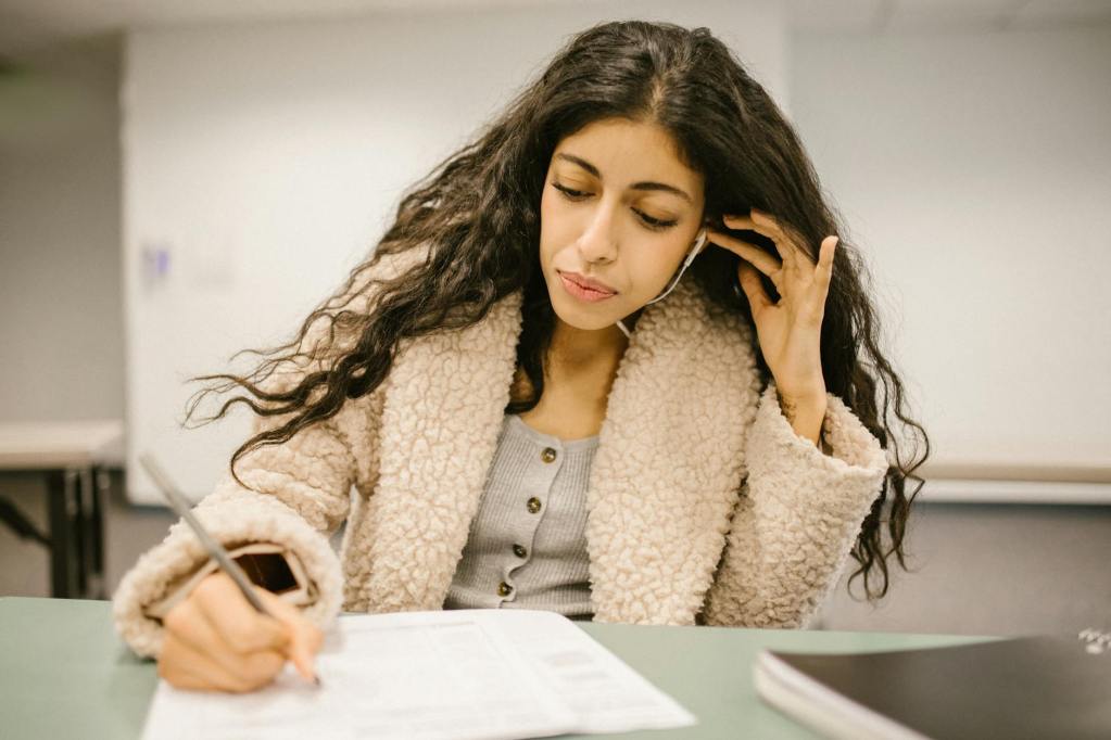 student cheating during an exam by using an earphone